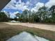 View of backyard with cleared land and tree line. Partially complete patio at 233 Locust Ln, Ocala, FL 34472