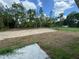 Large backyard with cleared space, ready for landscaping and featuring a partially finished patio at 233 Locust Ln, Ocala, FL 34472