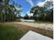 Large backyard with grassy area and partially cleared land at 235 Locust Ln, Ocala, FL 34472