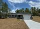 Newly constructed home with grey exterior and driveway at 235 Locust Ln, Ocala, FL 34472
