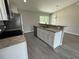 Kitchen with island, white cabinets, and stainless steel appliances at 235 Locust Ln, Ocala, FL 34472