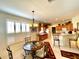 Kitchen and dining area combination with breakfast bar, chandelier, and view into kitchen at 15338 Sw 14Th Avenue Rd, Ocala, FL 34473