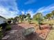 Landscaped backyard with palm trees, stone path, and a bench at 15338 Sw 14Th Avenue Rd, Ocala, FL 34473