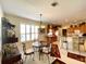 Kitchen and dining area combination with breakfast bar, chandelier, and view into kitchen at 15338 Sw 14Th Avenue Rd, Ocala, FL 34473