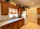 Kitchen with wood cabinets, white appliances, and a pantry at 15338 Sw 14Th Avenue Rd, Ocala, FL 34473