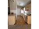 Long galley kitchen with light wood cabinets and flooring at 7946 Juniper Rd, Ocala, FL 34480