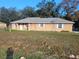 Single-story home with a yard and satellite dish at 7946 Juniper Rd, Ocala, FL 34480