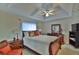 Main bedroom with sleigh bed, ceiling fan, and TV at 5247 Nw 18Th St, Ocala, FL 34482