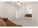 Bedroom with mirrored closet doors and brown sofa at 7127 Sw 91St Ct, Ocala, FL 34481