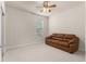 Bedroom with brown sofa and ceiling fan at 7127 Sw 91St Ct, Ocala, FL 34481