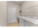 Laundry room with washer, dryer, and storage shelves at 7127 Sw 91St Ct, Ocala, FL 34481