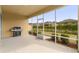 Relaxing screened patio with built-in grill and backyard access at 7127 Sw 91St Ct, Ocala, FL 34481