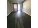 Spacious living room with dark grey vinyl plank flooring and access to balcony at 3545 E Fort King St # 257, Ocala, FL 34470