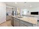 Kitchen with granite island, stainless steel appliances and view into living room at 4336 Nw 55Th Ct, Ocala, FL 34482
