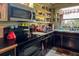 Well-equipped kitchen offering black cabinets, stainless steel appliances, and open shelving at 3751 Se 3Rd Ave, Ocala, FL 34471