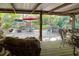 Spacious covered patio with seating and views of the backyard garden at 3751 Se 3Rd Ave, Ocala, FL 34471