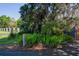 House entrance with lush landscaping and a wooden post marker at 3751 Se 3Rd Ave, Ocala, FL 34471