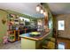 Kitchen with a breakfast bar, green cabinets, and decorative lighting at 3751 Se 3Rd Ave, Ocala, FL 34471