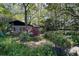 Ranch home with a vibrant flower garden in front at 3751 Se 3Rd Ave, Ocala, FL 34471