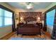 Spacious bedroom with hardwood floors, large windows, and a ceiling fan at 3751 Se 3Rd Ave, Ocala, FL 34471