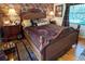 Main bedroom with leopard print bedding and rich wood furniture at 3751 Se 3Rd Ave, Ocala, FL 34471
