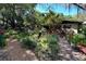 Lushly landscaped backyard with a pond and a tranquil garden path at 3751 Se 3Rd Ave, Ocala, FL 34471