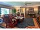 Living room features hardwood floors, comfortable seating, and a ceiling fan at 3751 Se 3Rd Ave, Ocala, FL 34471
