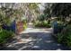 Long driveway leading to the home, gated entry with lush landscaping at 3751 Se 3Rd Ave, Ocala, FL 34471