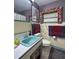 Retro bathroom with a teal sink and shower/tub combo at 3751 Se 3Rd Ave, Ocala, FL 34471