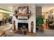 Brick fireplace with wooden mantel, decorative carvings, and unique decor at 3751 Se 3Rd Ave, Ocala, FL 34471