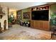 Bright living room with hardwood floors, built-in shelving and a large TV at 3751 Se 3Rd Ave, Ocala, FL 34471