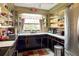 Retro kitchen with black cabinets, ample storage, and a window overlooking the backyard at 3751 Se 3Rd Ave, Ocala, FL 34471