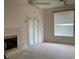 Living room with fireplace and French doors leading outside at 610 Grand Vista Trl, Leesburg, FL 34748