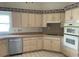 Bright kitchen featuring updated appliances and wood cabinets at 610 Grand Vista Trl, Leesburg, FL 34748