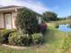 House exterior showcasing landscaping and a pond view at 610 Grand Vista Trl, Leesburg, FL 34748