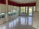 Sunroom with tiled floor and view of backyard lake at 610 Grand Vista Trl, Leesburg, FL 34748