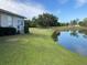 Home with backyard access to a pond and golf course views at 610 Grand Vista Trl, Leesburg, FL 34748