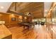 Game room with a pool table, hardwood floors, and wood-paneled walls at 2162 Se Mill Creek Cir, Ocala, FL 34471