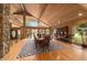 Spacious dining room with hardwood floors, a large table, and a stone fireplace at 2162 Se Mill Creek Cir, Ocala, FL 34471