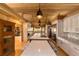 Modern kitchen features large island, stainless steel appliances, and a wood ceiling at 2162 Se Mill Creek Cir, Ocala, FL 34471