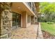Stone patio with access to backyard and surrounding nature at 2162 Se Mill Creek Cir, Ocala, FL 34471