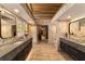 Modern bathroom with dual vanities, marble countertops, and stylish wallpaper at 2162 Se Mill Creek Cir, Ocala, FL 34471