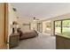 Large main bedroom with plush carpeting and access to backyard at 2162 Se Mill Creek Cir, Ocala, FL 34471