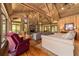 Open living room with hardwood floors, vaulted wood ceilings and stone fireplace at 2162 Se Mill Creek Cir, Ocala, FL 34471