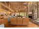 Living room boasts a stone fireplace, vaulted wood ceiling, and hardwood floors at 2162 Se Mill Creek Cir, Ocala, FL 34471