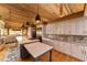 Bright kitchen with white cabinets, center island, and high-end stainless steel appliances at 2162 Se Mill Creek Cir, Ocala, FL 34471