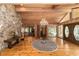 Elegant entryway with wood floors, stone wall, and large chandelier at 2162 Se Mill Creek Cir, Ocala, FL 34471