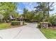 Long driveway leading to a charming home with stone pillars at 2162 Se Mill Creek Cir, Ocala, FL 34471