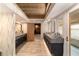 Spa-like bathroom with dual vanities, marble countertops, and stylish wallpaper at 2162 Se Mill Creek Cir, Ocala, FL 34471