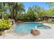 Inviting kidney-shaped pool with spa and waterfall feature at 2162 Se Mill Creek Cir, Ocala, FL 34471
